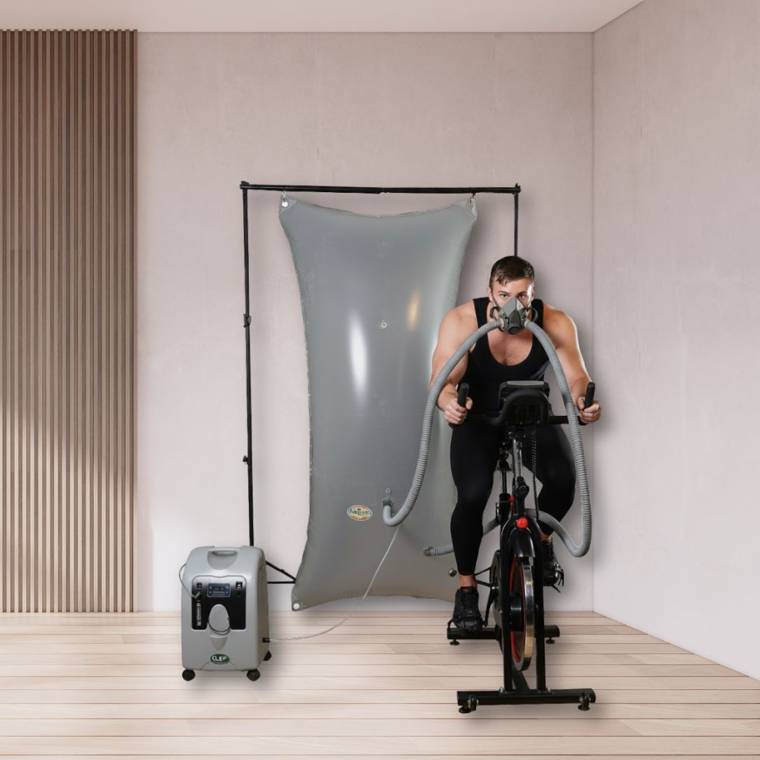Athletic man exercising on a cycle with Turbo Oxygen EWOT System
